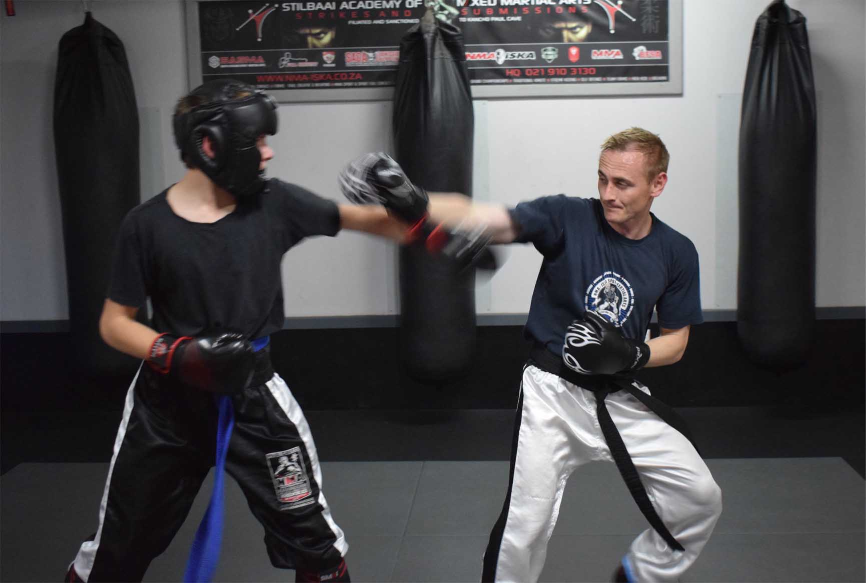 Kickboxers sparring in a training ring